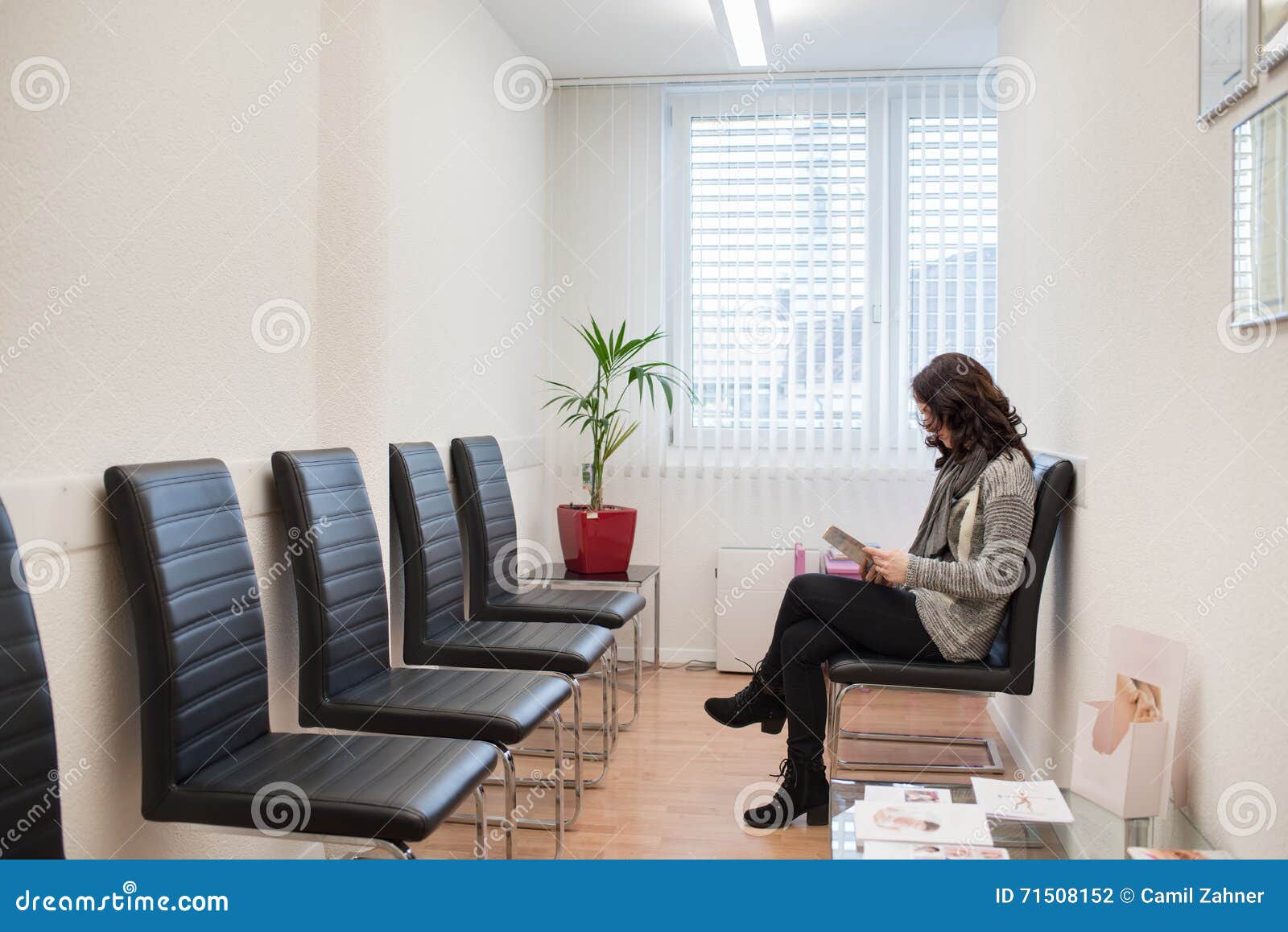 patient reading a magazine in the doctorÃ¢â¬â¢s waiting room